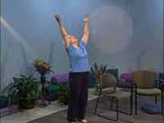 standing woman reaches up with both arms